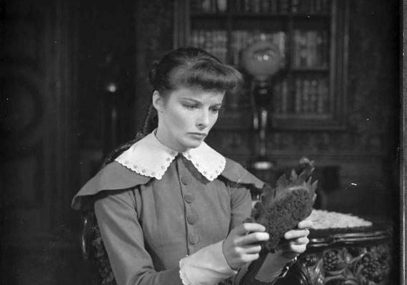 Photograph of Katharine Hepburn holding and looking into a hand mirror